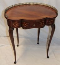 A 20th century inlaid and polished mahogany kidney-shaped side table with brass gallery rail and a