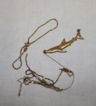 A 9ct gold shark pendant with necklace chain and two other 9ct gold bracelets (4g)