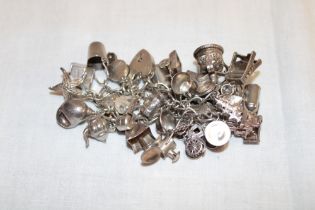 A silver charm bracelet supporting numerous silver and other charms