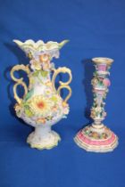 A German porcelain candlestick decorated all over with raised flowers,