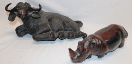 An Eastern carved wood figure of a recumbent water buffalo,