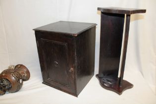 An old oak table cabinet with shelves enclosed by a single panelled door,