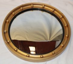 A good quality convex circular wall mirror in ornate gilt frame,