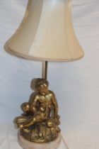 A good quality gilt spelter table lamp in the form of a seated cherub