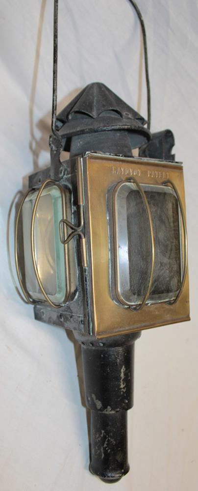 An old brass mounted metal coaching lamp by "The Raydyot Patent" with candle fitment