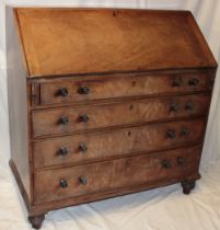 A George III mahogany bureau with numerous drawers and pigeon holes enclosed by a fall front above