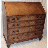 A George III mahogany bureau with numerous drawers and pigeon holes enclosed by a fall front above