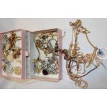 A jewellery chest containing a quantity of various costume jewellery including necklaces,