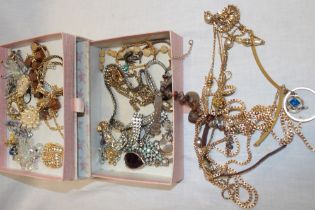 A jewellery chest containing a quantity of various costume jewellery including necklaces,