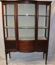 A late Victorian inlaid mahogany display cabinet with fabric lined shelves enclosed by a central