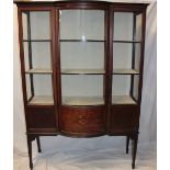 A late Victorian inlaid mahogany display cabinet with fabric lined shelves enclosed by a central