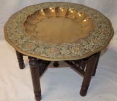 A large Indian brass top occasional table with recessed centre and floral decorated borders,