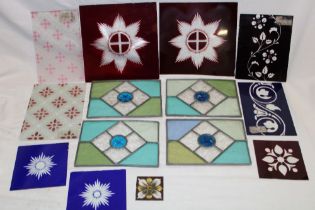 Four small stained leaded glass panels, 5½" x 7½"; a pair of ruby tinted glass star-cut panels,