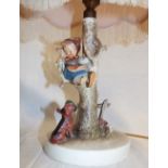 A Goebel china table lamp in the form of a child climbing a tree