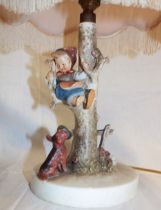 A Goebel china table lamp in the form of a child climbing a tree