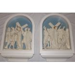 A pair of old plaster arched religious niches depicting religious figures in arched mounts,