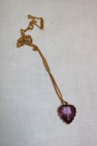 A 9ct gold heart-shaped pendant set amethyst with 9ct chain necklace (6.