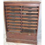 A 1920's/30's oak filing cabinet with a double bank of sliding trays enclosed by a tambour shutter