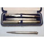 A silver cased propelling pencil and three other various pens/pencils