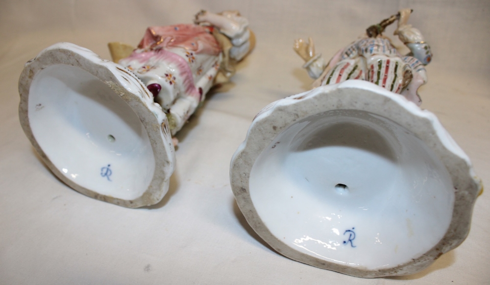 A pair of German porcelain ornamental candlesticks as a classical male and female on scroll-shaped - Image 2 of 2