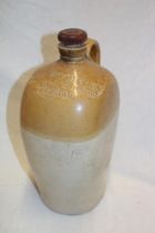 An unusual 19th century stoneware flagon with flattened sides and loop-handle by Joseph Woolfrey