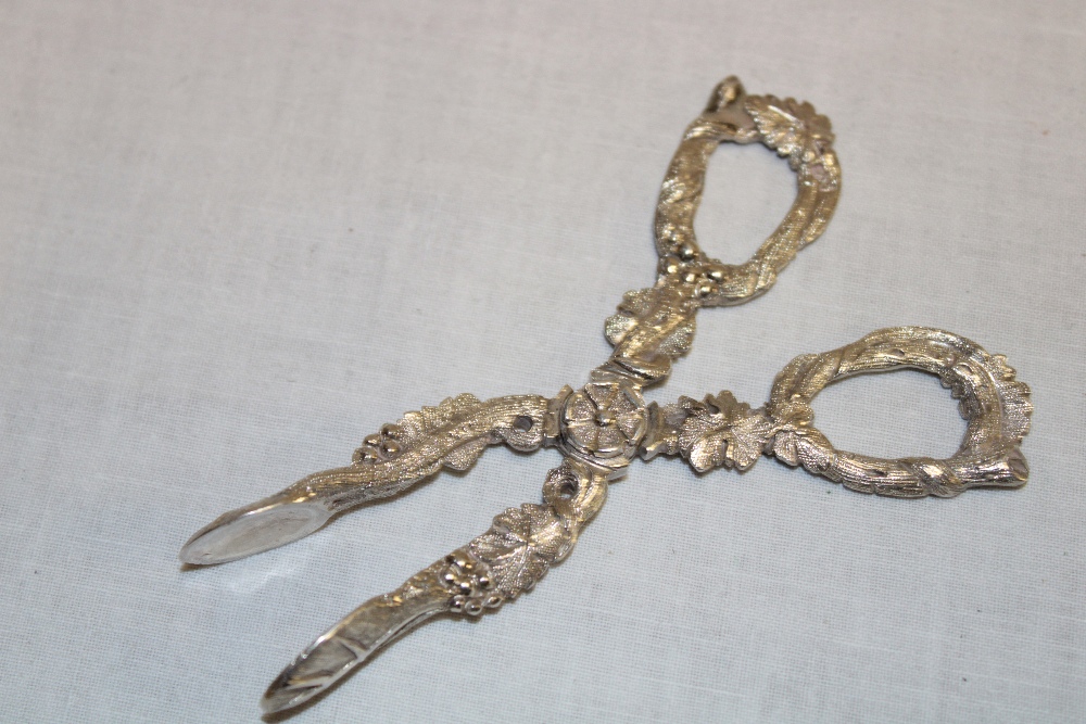 A Victorian silver scissor-action sugar tongs decorated all over with grape leaves and grapes,