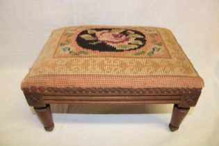 A Victorian carved beech rectangular footstool with floral tapestry upholstered seat,