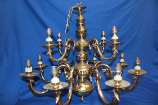 A good quality brass twelve branch ceiling chandelier with scroll supports,