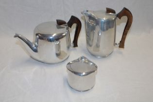 A 1960's/70's Picquot Ware three-piece tea set with polished teak handles