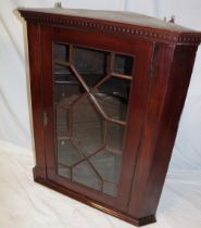 A Victorian mahogany hanging corner cupboard with shaped shelves enclosed by an astragal glazed