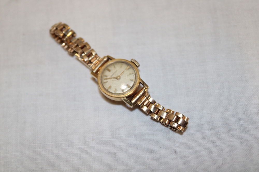 A ladies 18ct gold wristwatch by Certina with plated strap