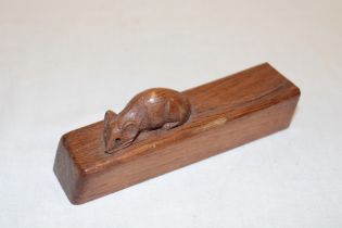 A piece of carved oak by Robert Thompson depicting a carved mouse 5" long