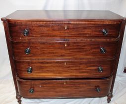 A mid 19th century mahogany curved front chest of four long graduated drawers with turned handles