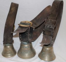 Three early Swiss bronze cow bells with original leather straps and buckles,