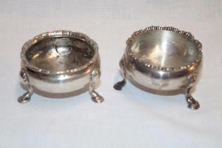 A George III silver circular salt with decorated edge on three-hooved feet,