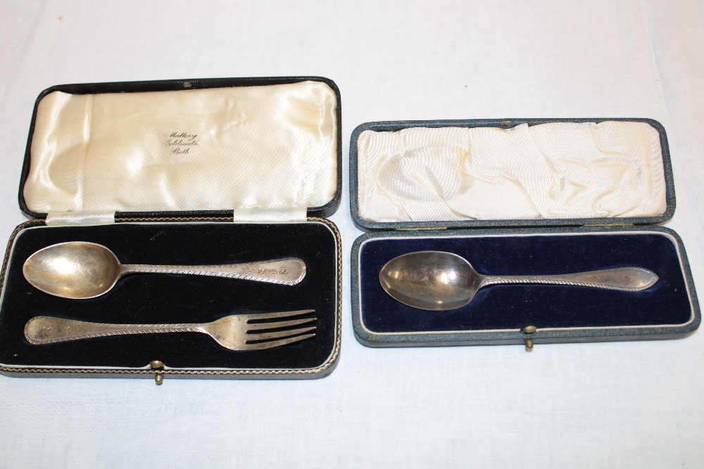 A silver Christening spoon and fork with feather-edged handles,