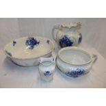 A Staffordshire pottery "Nasturtium" pattern blue and white floral toilet set comprising wash bowl,