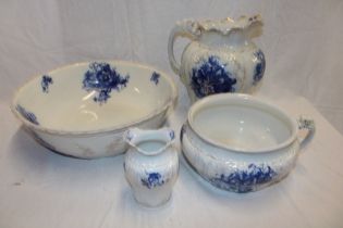 A Staffordshire pottery "Nasturtium" pattern blue and white floral toilet set comprising wash bowl,