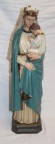 A painted plaster figure of The Virgin Mary with Jesus on square-shaped base,