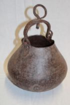 An old iron circular cauldron with iron ring handle,