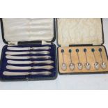 A set of six silver coffee spoons with blue enamelled terminals,