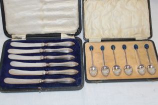 A set of six silver coffee spoons with blue enamelled terminals,