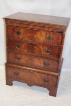 A good quality reproduction mahogany chest of three short drawers above one additional base drawer