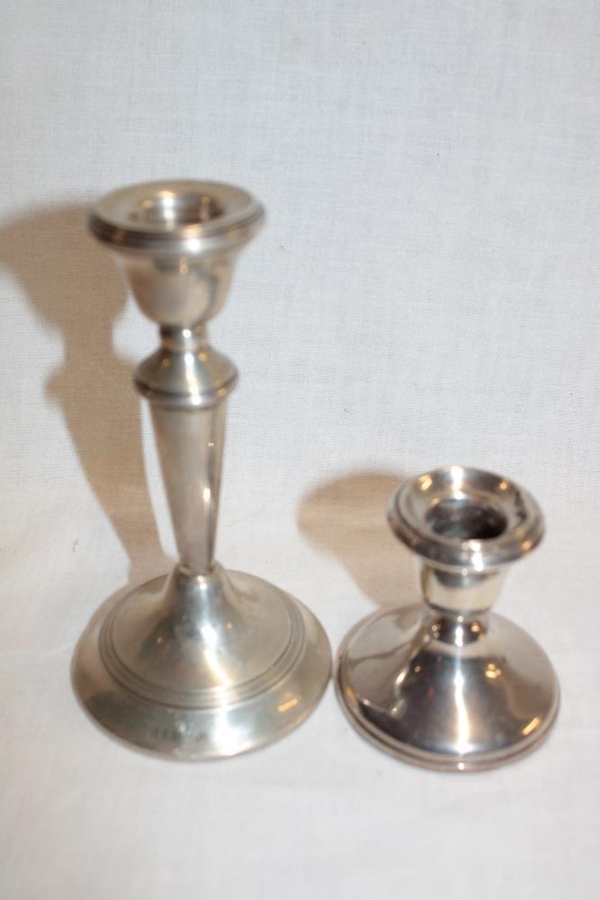 A silver balluster-shaped candlestick,