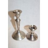 A silver balluster-shaped candlestick,