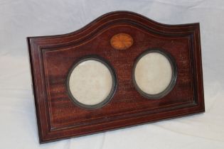 A late Victorian inlaid mahogany arched photo frame with twin circular mounts,