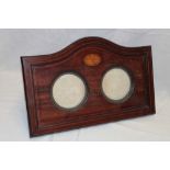 A late Victorian inlaid mahogany arched photo frame with twin circular mounts,