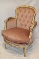 A 20th Century French gilt and cream painted salon chair upholstered in pink buttoned fabric on