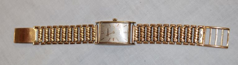 A gentleman's 18ct gold wristwatch by Urbex with silvered rectangular dial and 18ct gold strap