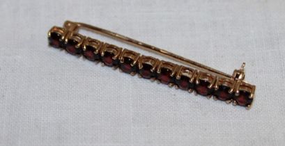 A 9ct gold bar brooch set garnets (3.